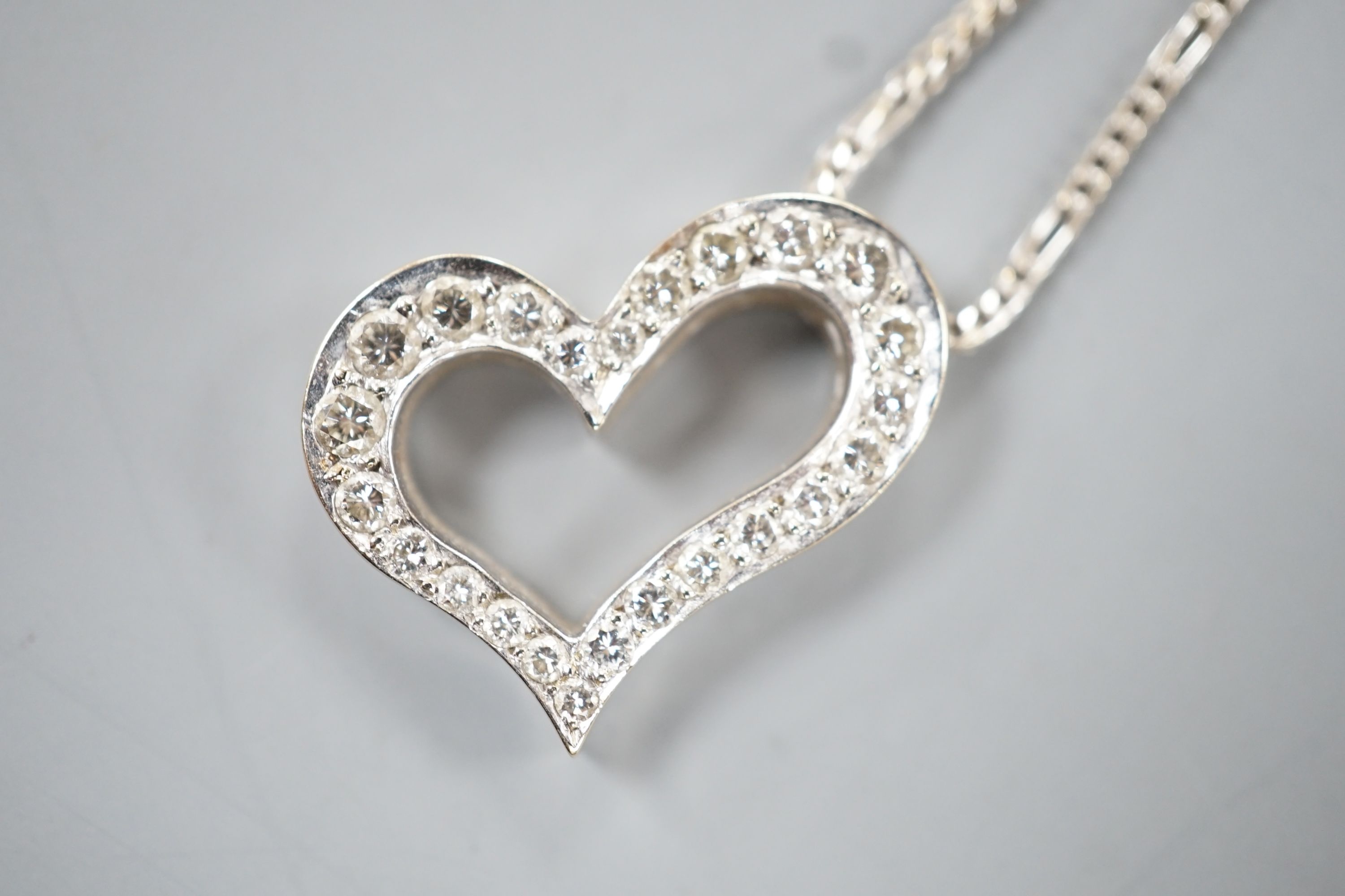 A modern 750 white metal and diamond set openwork heart pendant necklace, pendant width 22mm, chain, 40cm